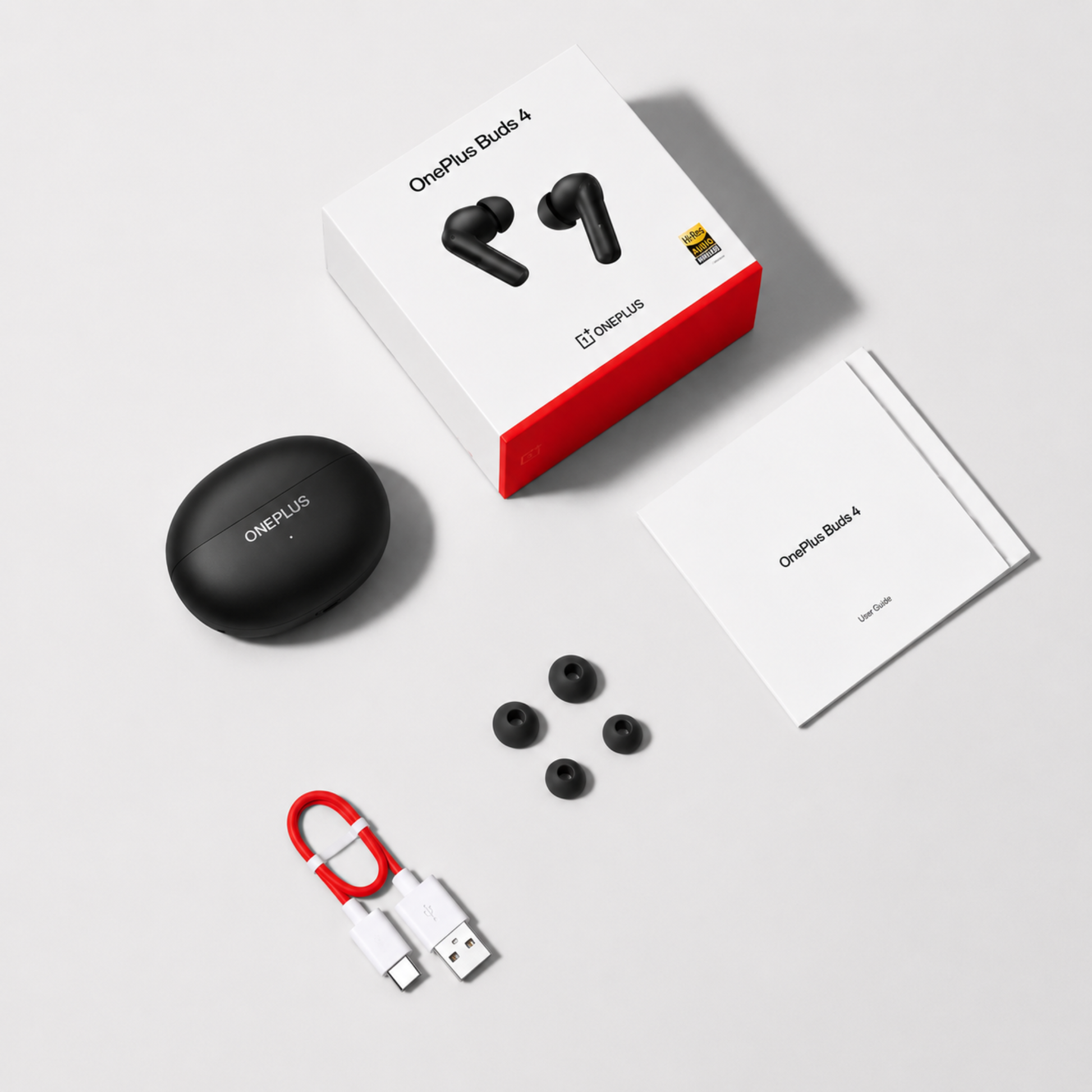 OnePlus Buds 4 Black complete in-box contents including earbuds, charging case, USB-C cable, ear tips, and user guide